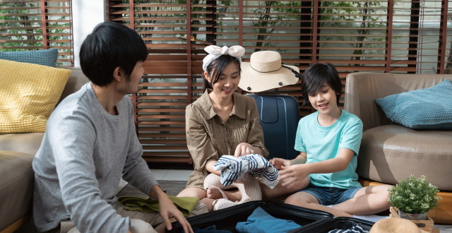 Happy family packing luggage