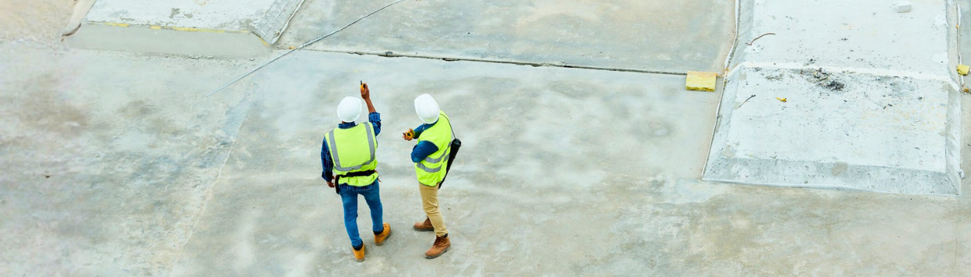 2 men at construction site wearing PPE