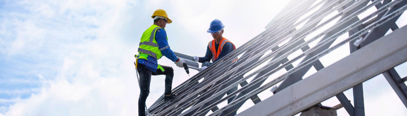 Construction workers working on roof structure