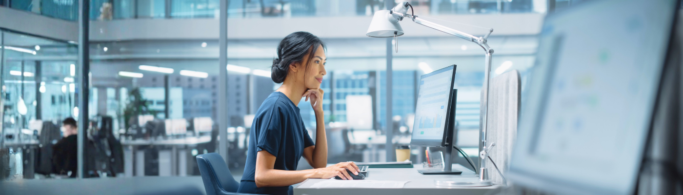 Asian Manager Using Desktop Computer