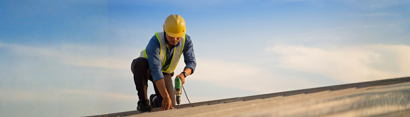 Worker repairing the roof on a construction site