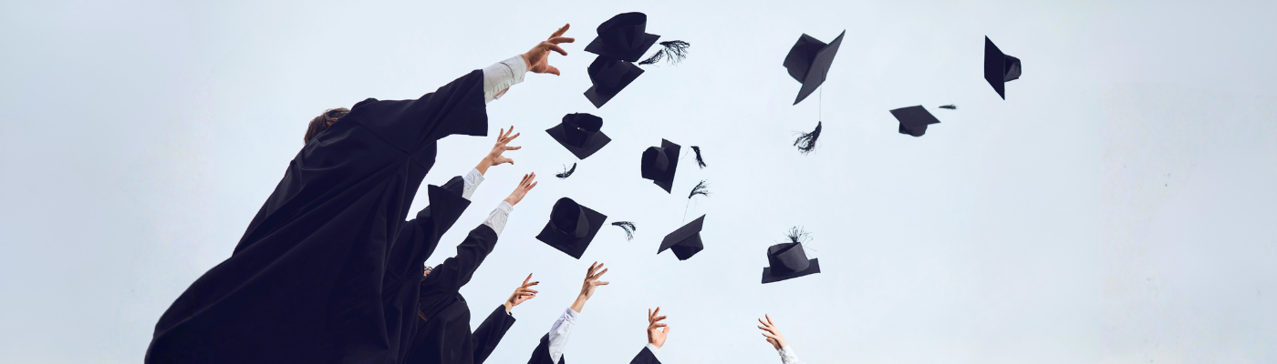 Graduates throwing hats to the sky