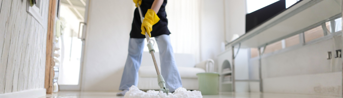 Helper mopping floor at home 