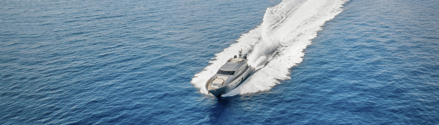Aerial view of a yacht cruising with speed over the ocean