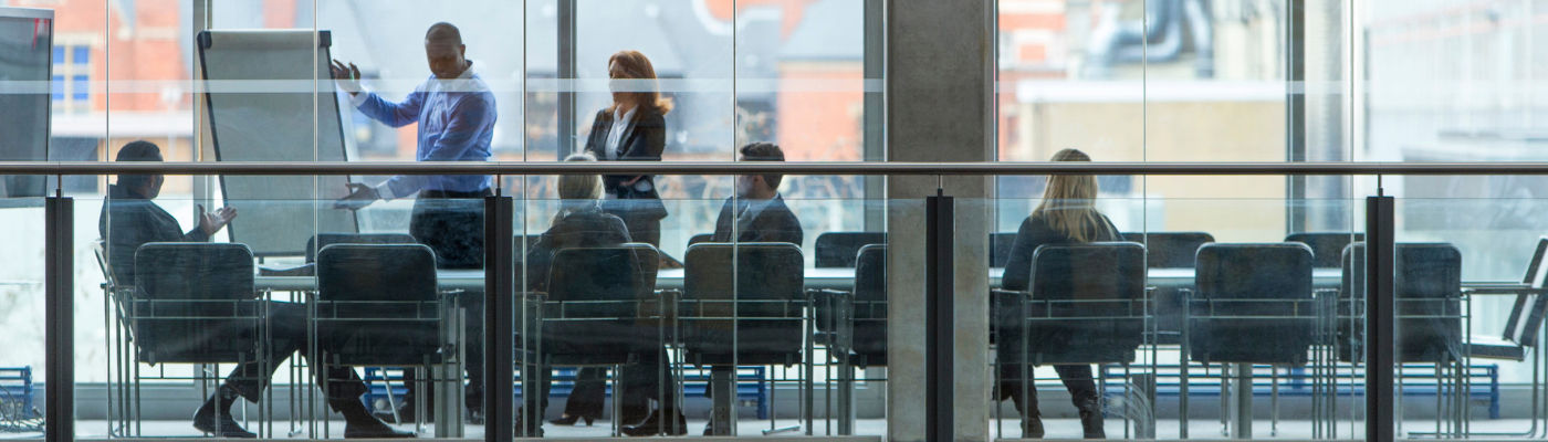 Group of six business people in a boardroom meeting