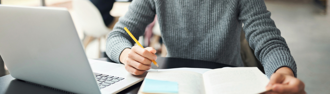 Asian man, with laptop and notebook, learning or studying in college