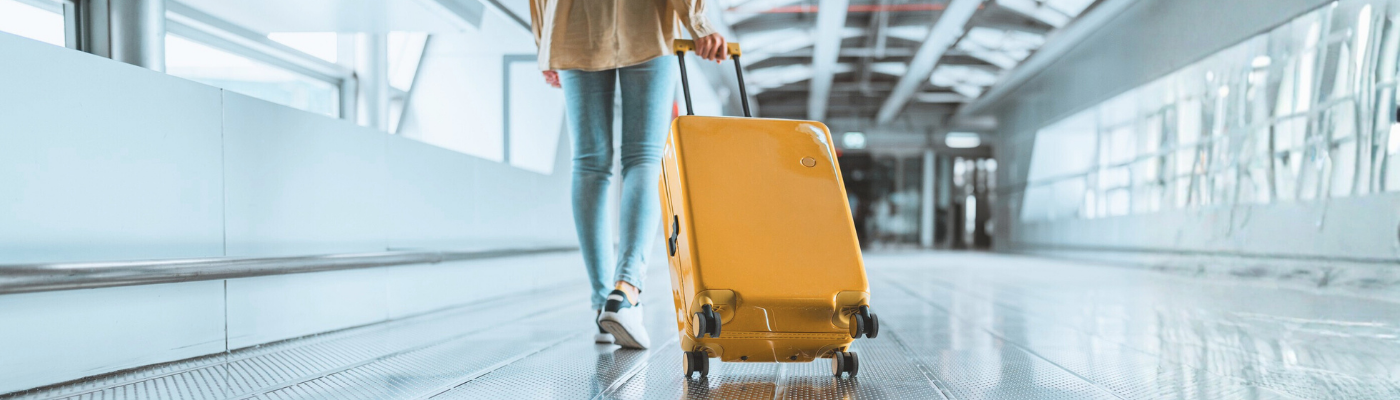 Woman pulling yellow suitcase