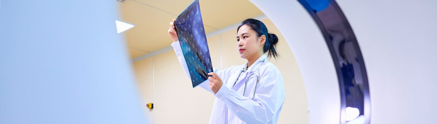 Female Doctor Checking Film at MRI-scanner Room