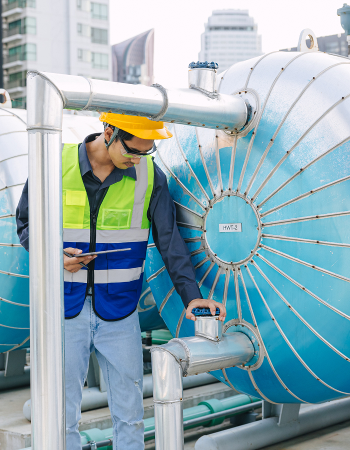 Male technician worker working service boiler tank 