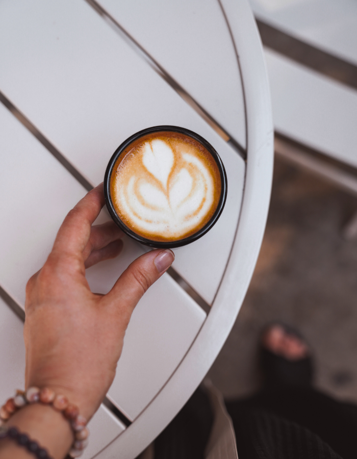 Hand and a cup of coffee
