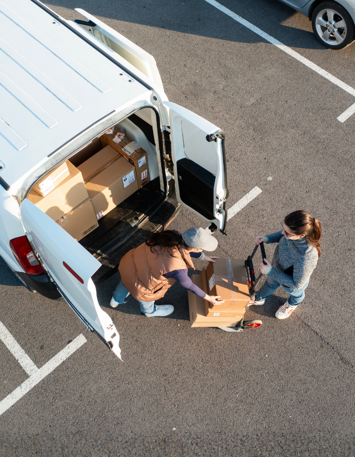 Delivery workers loading boxes in van