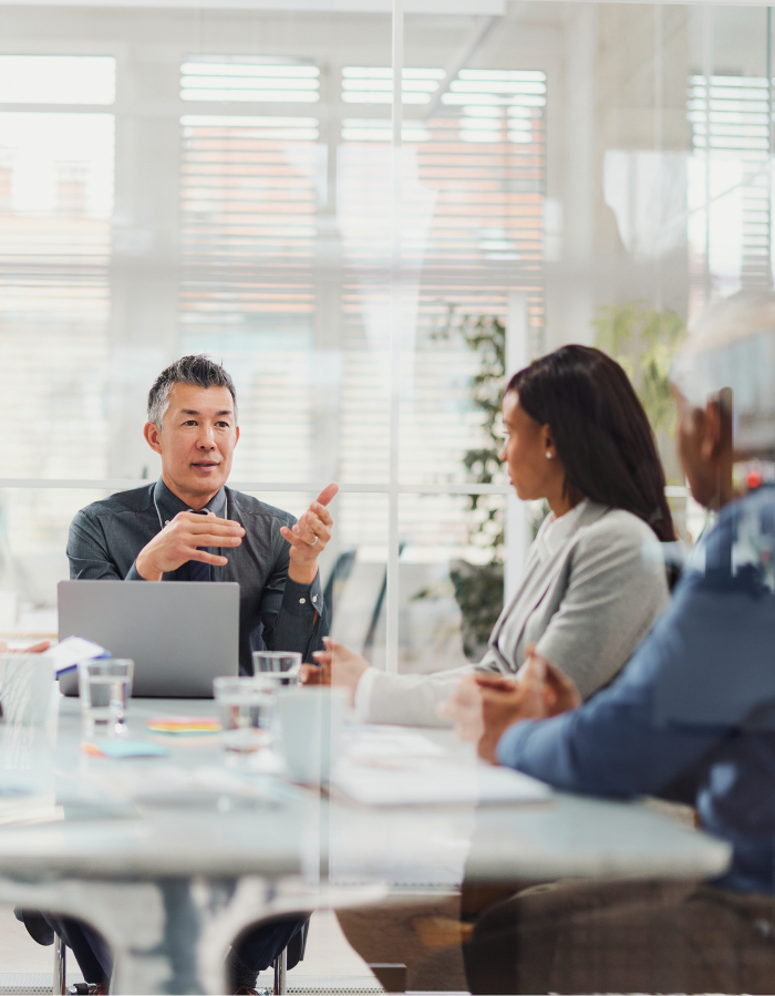 Asian manager talking to his colleagues