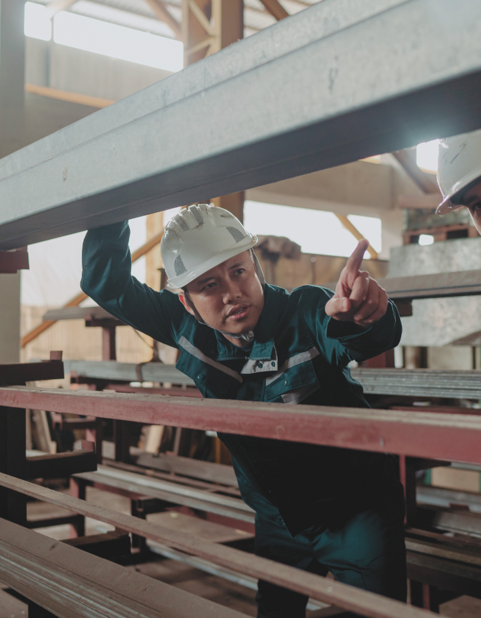 Asian industrial workers carrying out safety checks at a steel factory