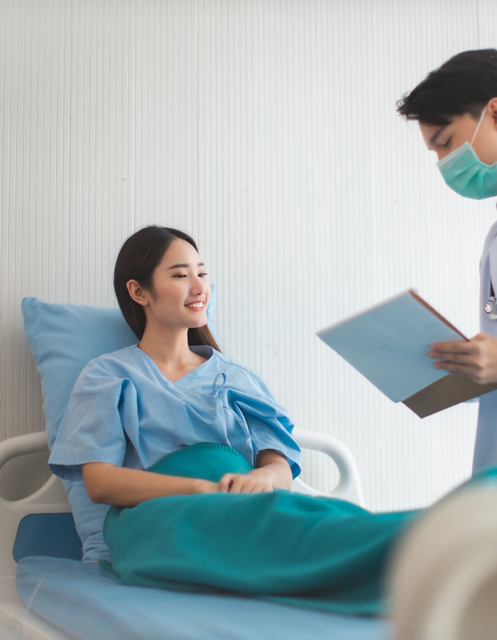 Asian doctor is taking care patient woman in hospital