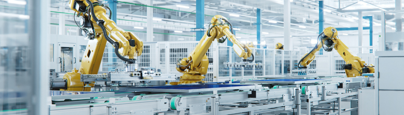 Large production line with industrial robot arms at modern bright factory