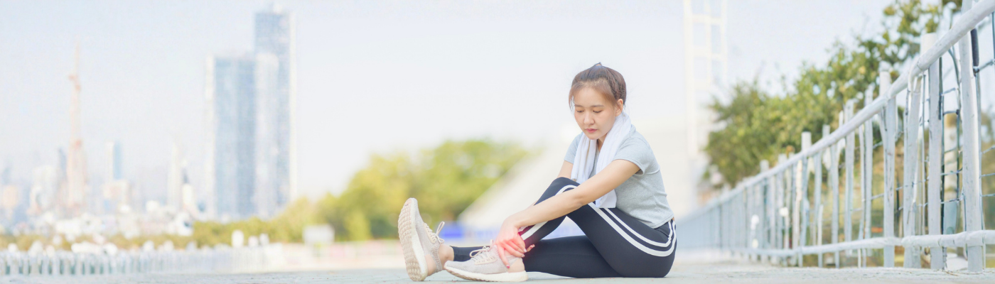 Woman touching twisted ankle