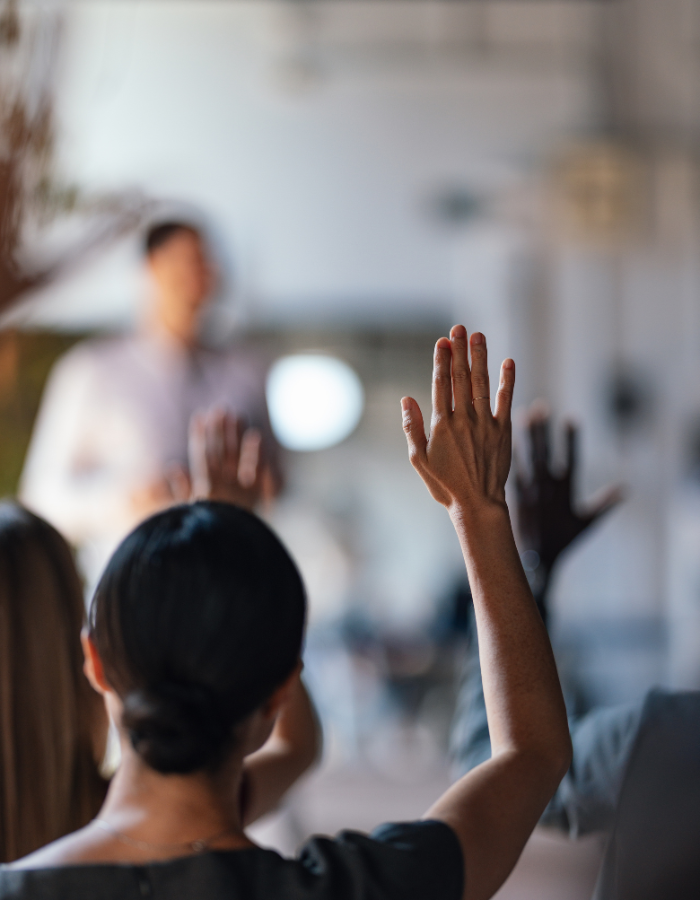 People Raising Hands at a Business Conference