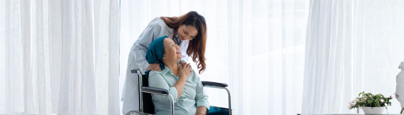 Female doctor was encouraging and inquiring about the symptoms of the elderly patient