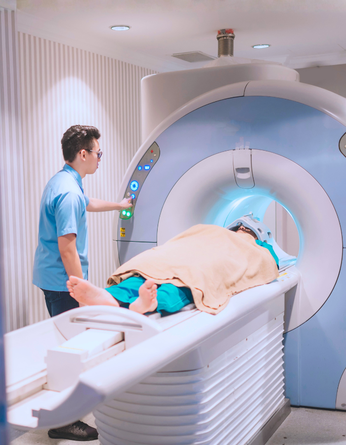 An asian chinese male nurse getting ready to perform MRI scan for a male patient in the MRI room