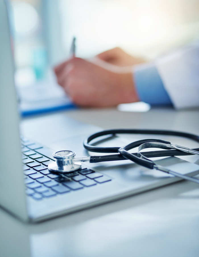 A stethoscope resting on a laptop 