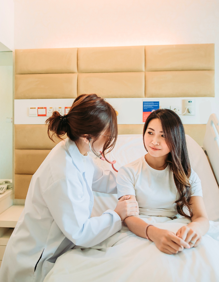 Asian Chinese female doctor examining her female patient with stethoscope 