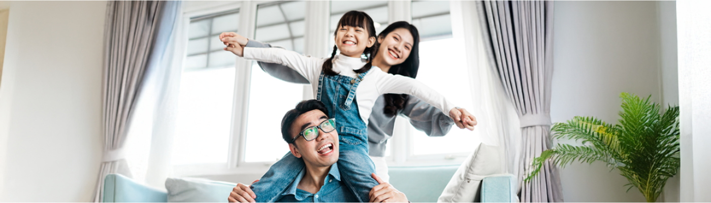 Happy Asian family having fun in living room